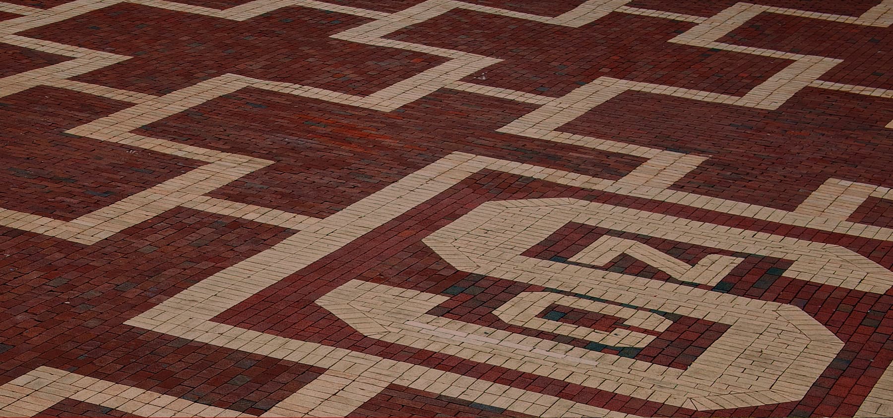 Patterned area of bricks with the NC State block S logo