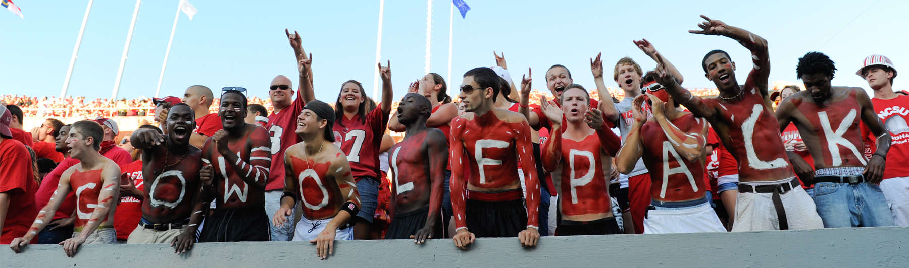 NC State fans go all-out with the red and white paint as they cheer on the Pack during a game against Western Carolina at Carter-Finley stadium in September of 2010.