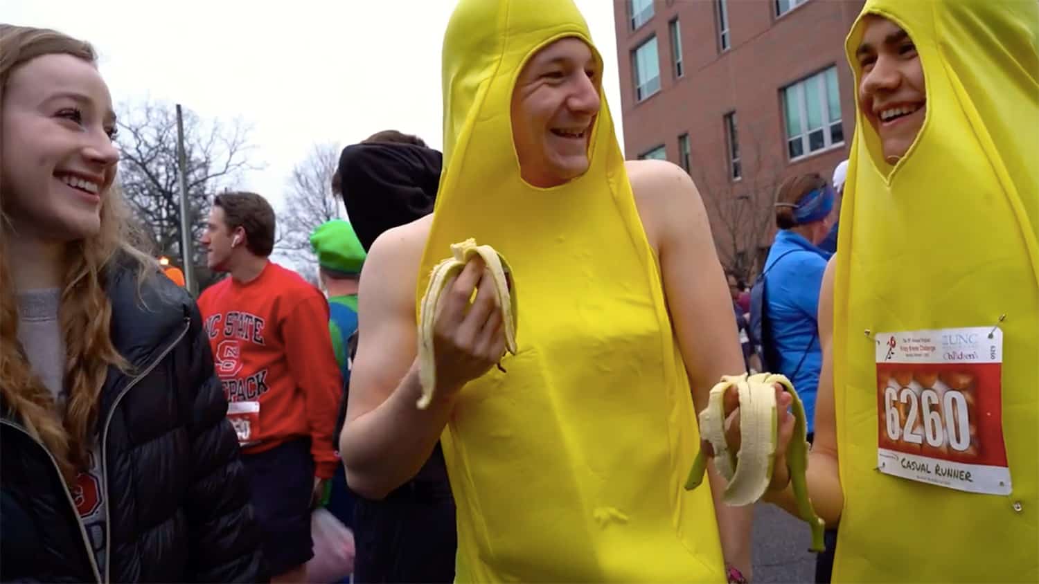 Two students in banana suits are interviewed at the 2020 Krispy Kreme Challenge.