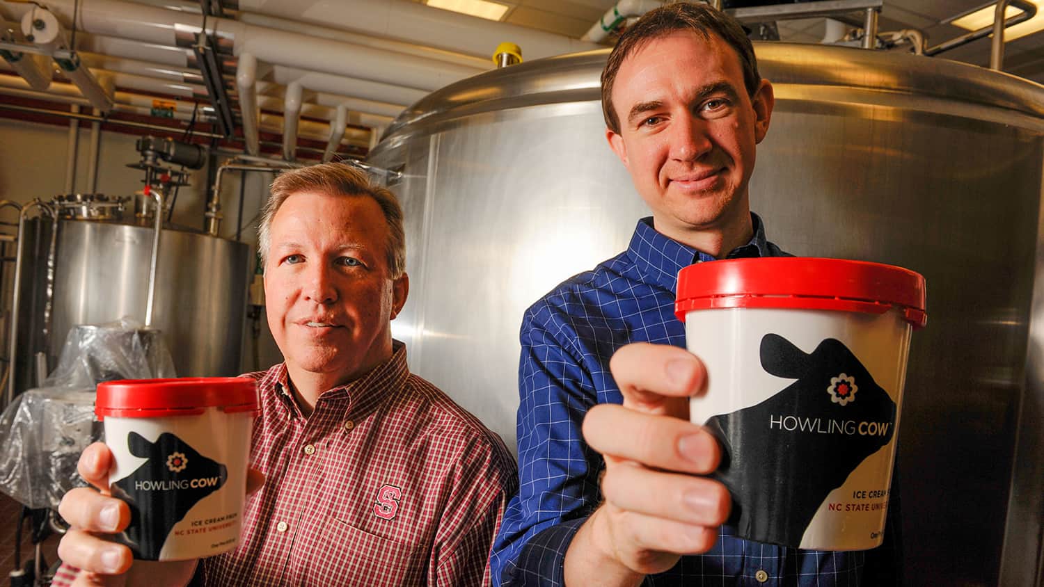 Gary Cartwright and Carl Hollifield display their Howling Cow ice cream in the lab.