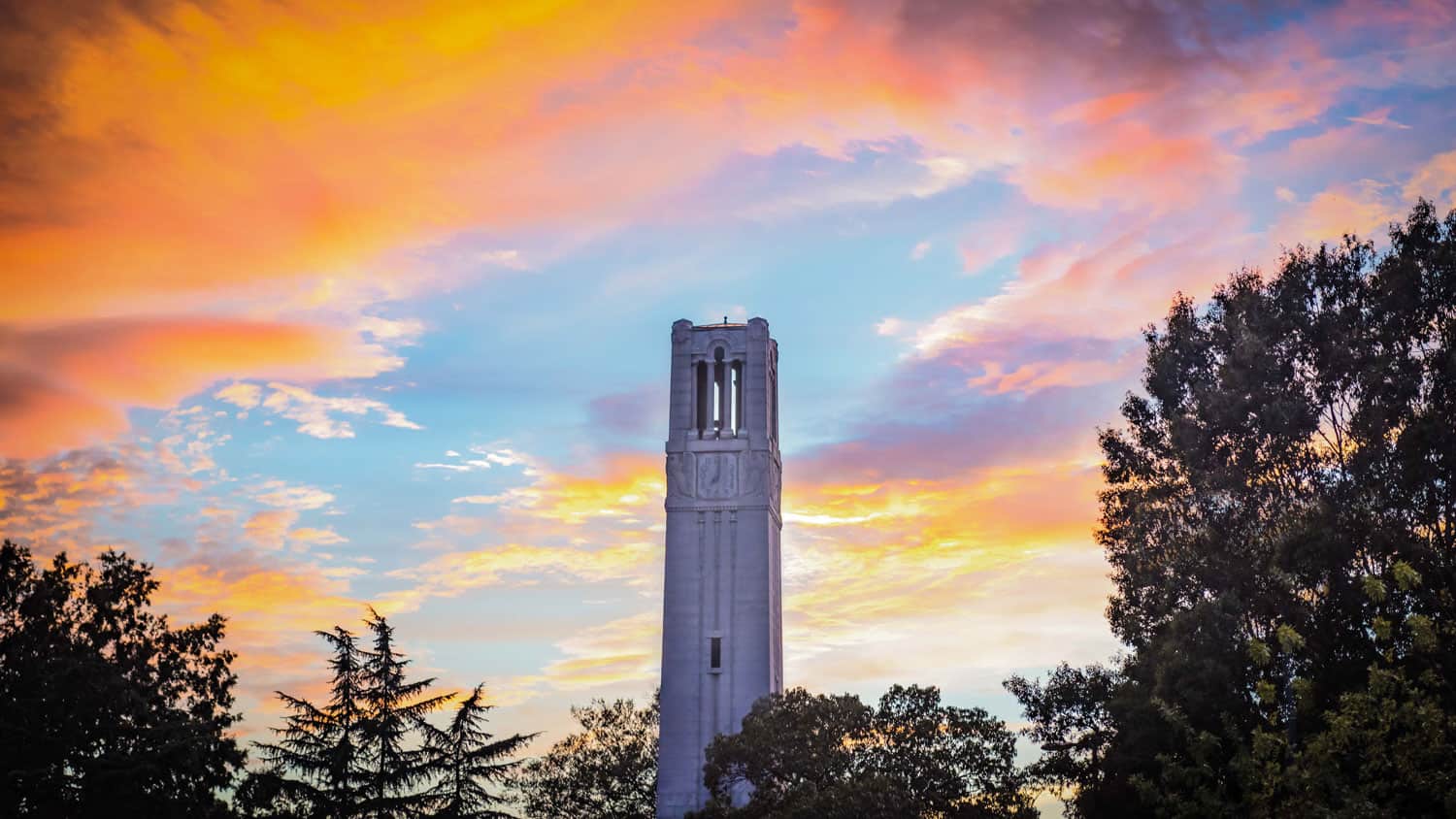 A golden sunset behind the Belltower on NC State's main campus.