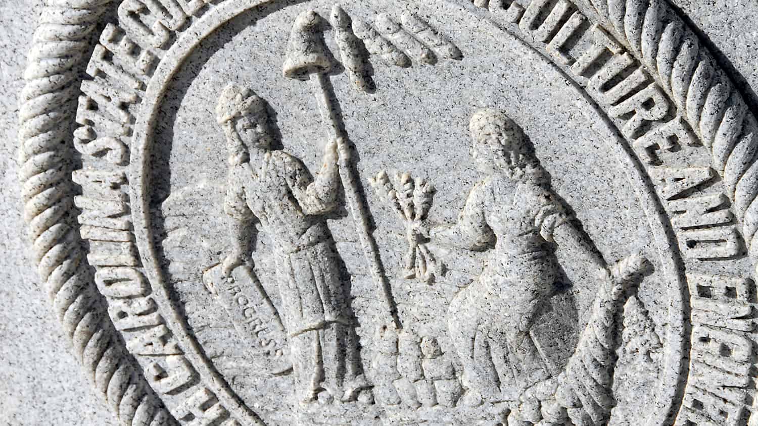 NC State University's seal etched in stone on the Memorial Belltower.