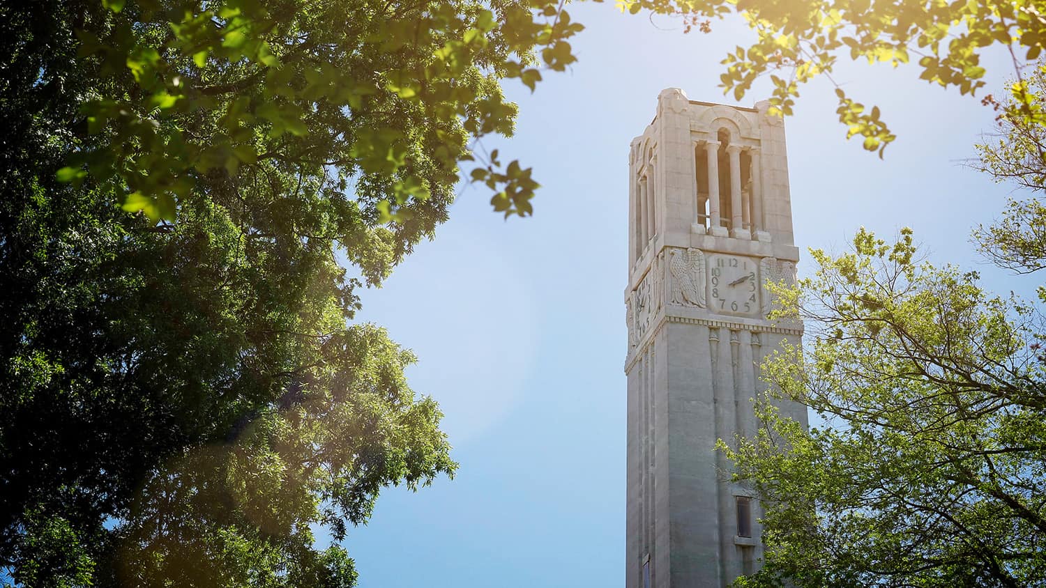 The NC State belltower shines as a beacon of hope over the campus of NC State.