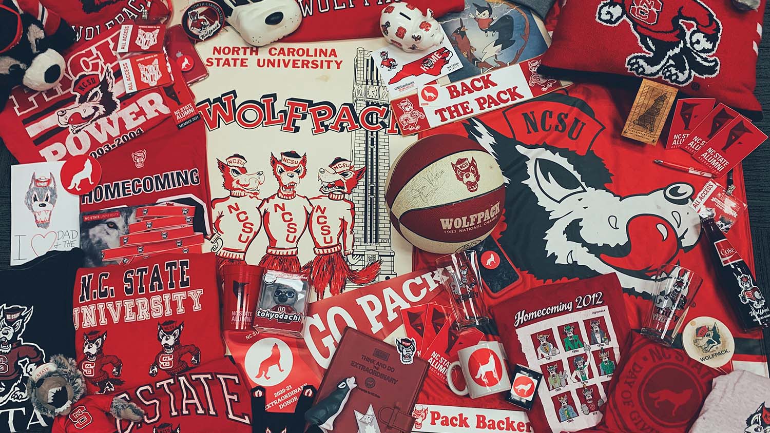 A flat lay image of Wolfpack paraphernalia that features 100 wolves.