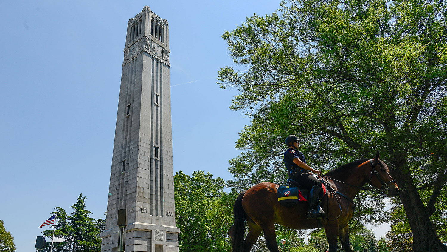 NC State mounted police patrol on horse through main campus.