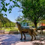 Copper wolves howling outside of Stafford Commons.
