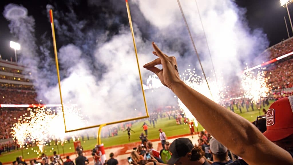 Fans cheer as the Wolfpack run out onto the field at Carter-Finley Stadium.