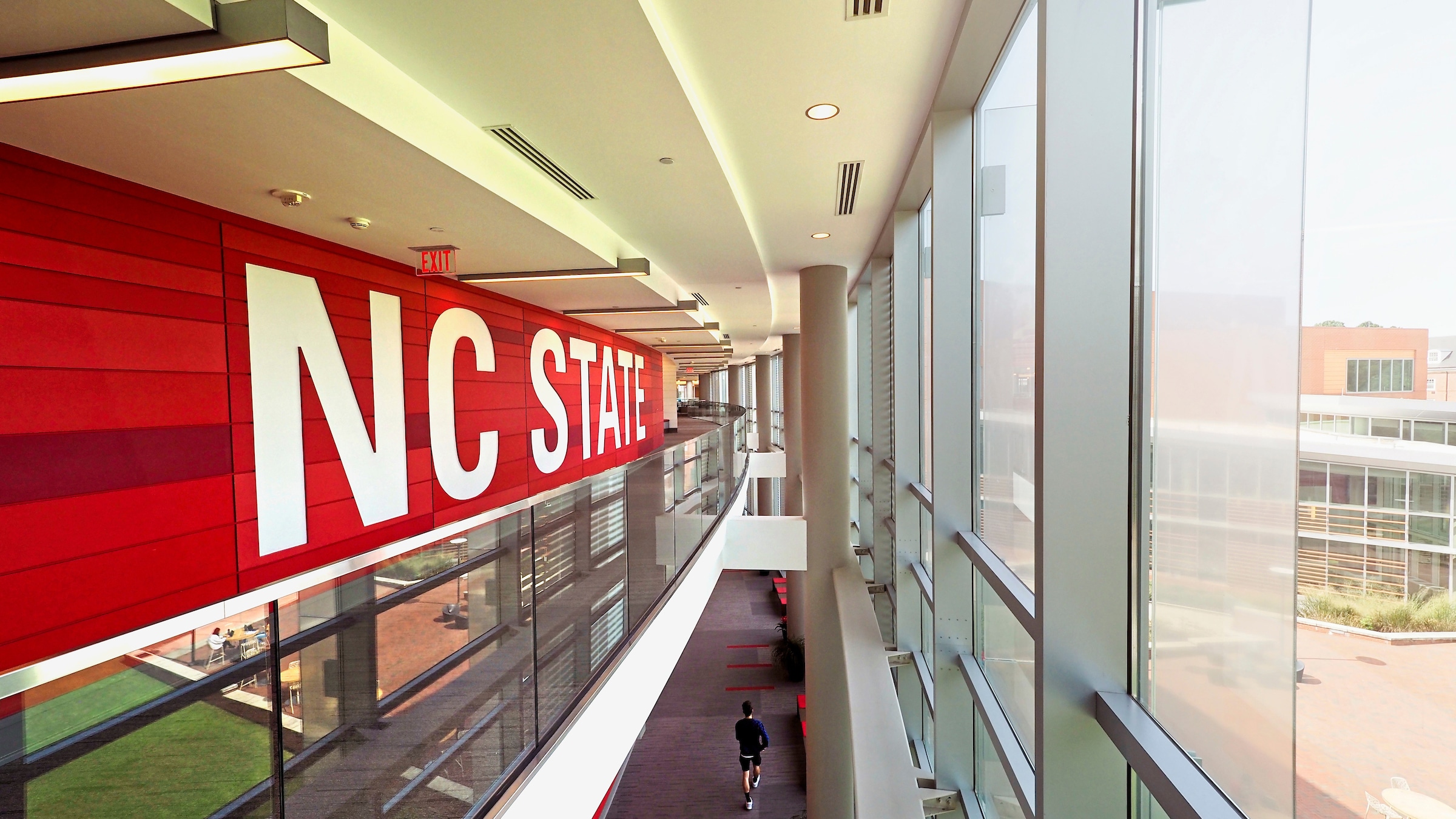 An interior of the Talley Student Union with the large NC State signage.