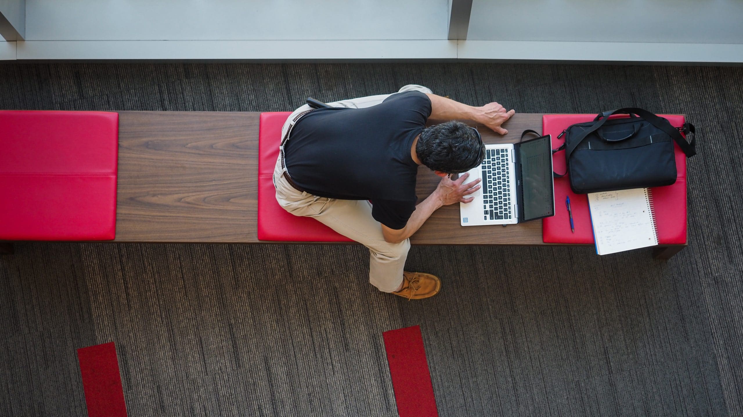 A student works on his laptop in the hallway of Talley Student union.