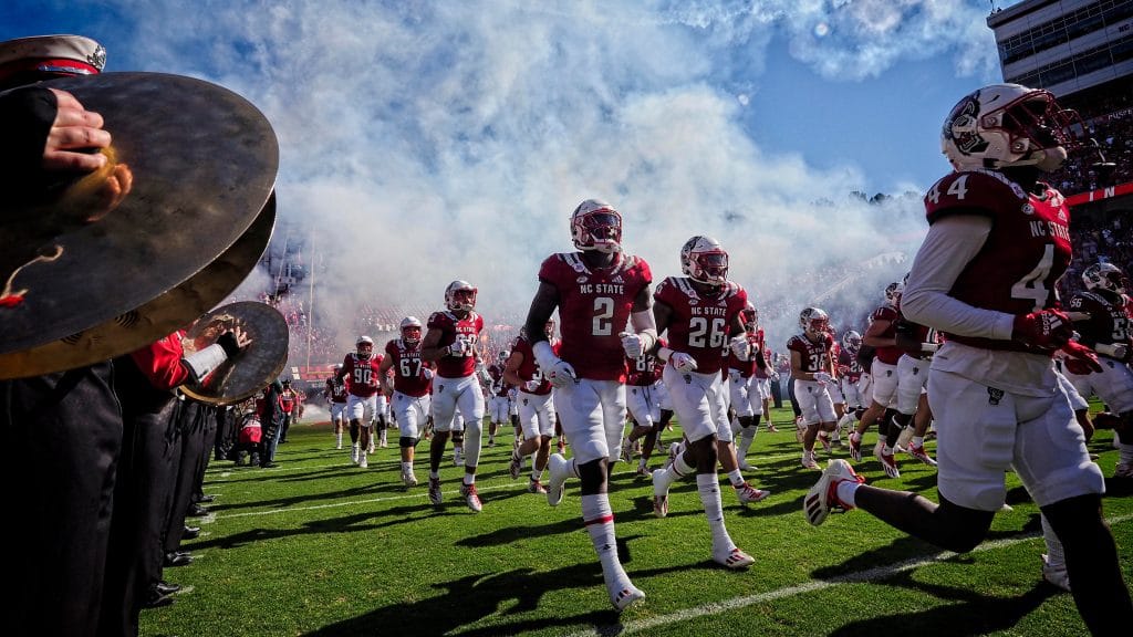 The NC State football team takes to the field against Clemson in 2021.