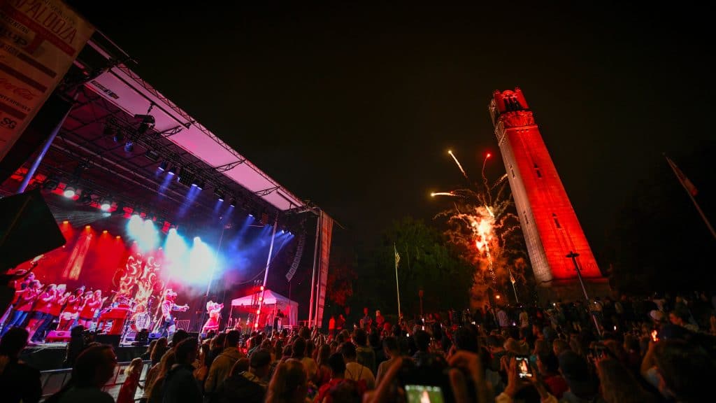 The NC State belltower is lit red at Packapalooza 2019.