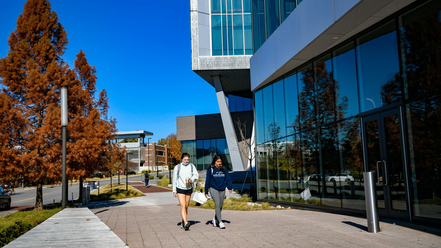 Students pass the newly completed Fitts-Woolard Engineering Building on their way to the Hunt Library entrance on Centennial Campus.