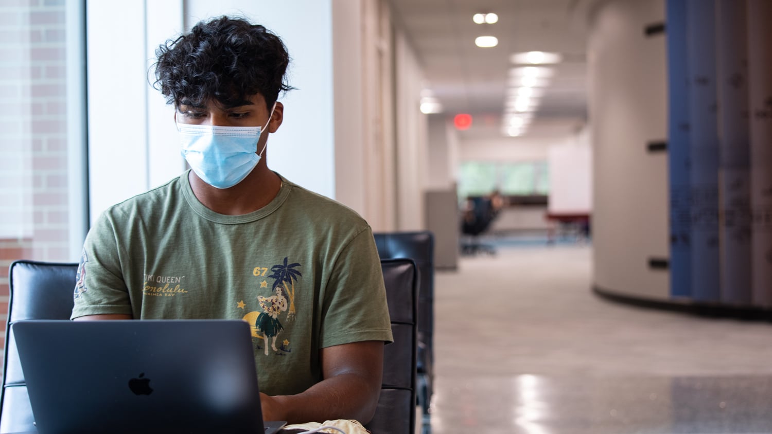 Student works with a mask at DH Hill Library.