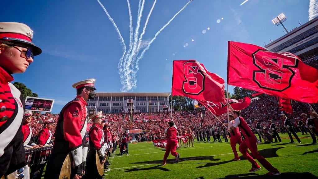 The NC State football team takes to the field against Clemson in 2021.