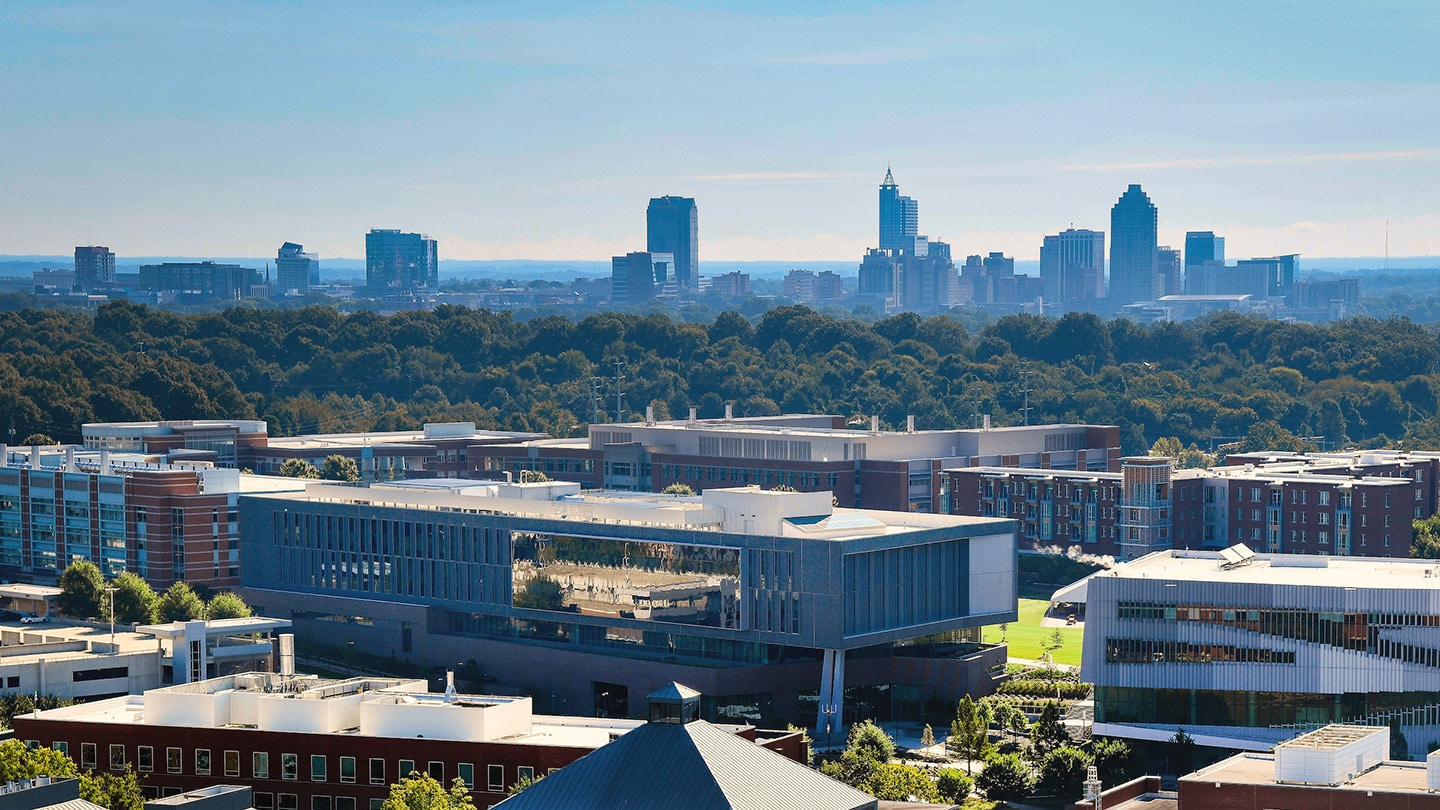 The Raleigh skyline is seen beyond NC State's Centennial Campus in an aerial photograph.
