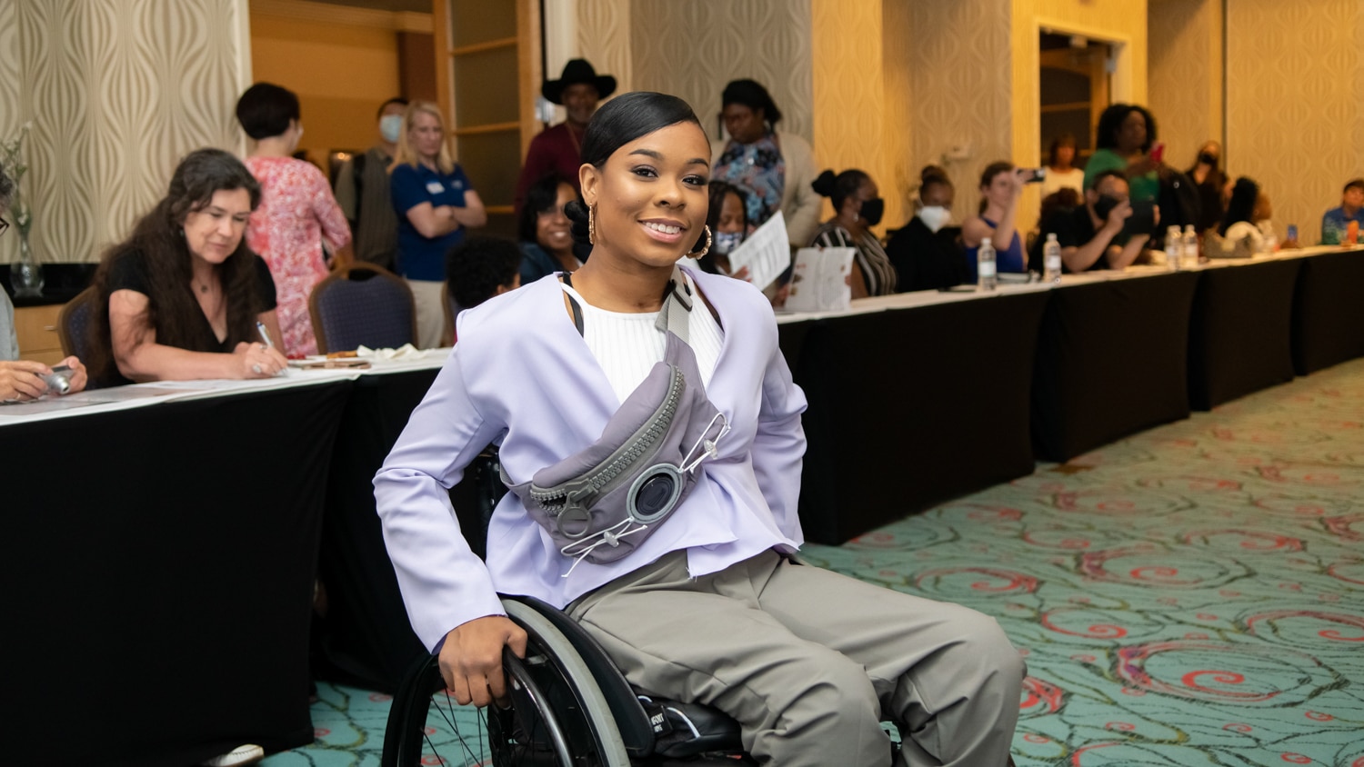 A wheelchair user shows off her fashionable lavender outfit during the “A Voice at the Table" conference.