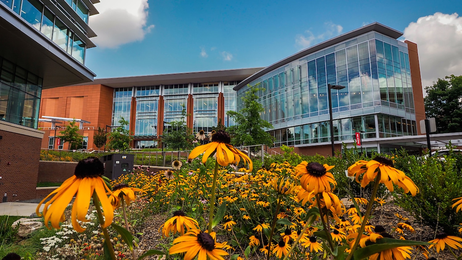 Talley Student Union today, with summer flowers in the foreground.