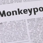 A piece of newspaper with the word "Monkeypox" enlarged.