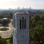 The Belltower stands tall and proud above Raleigh, with the downtown skyline close behind.