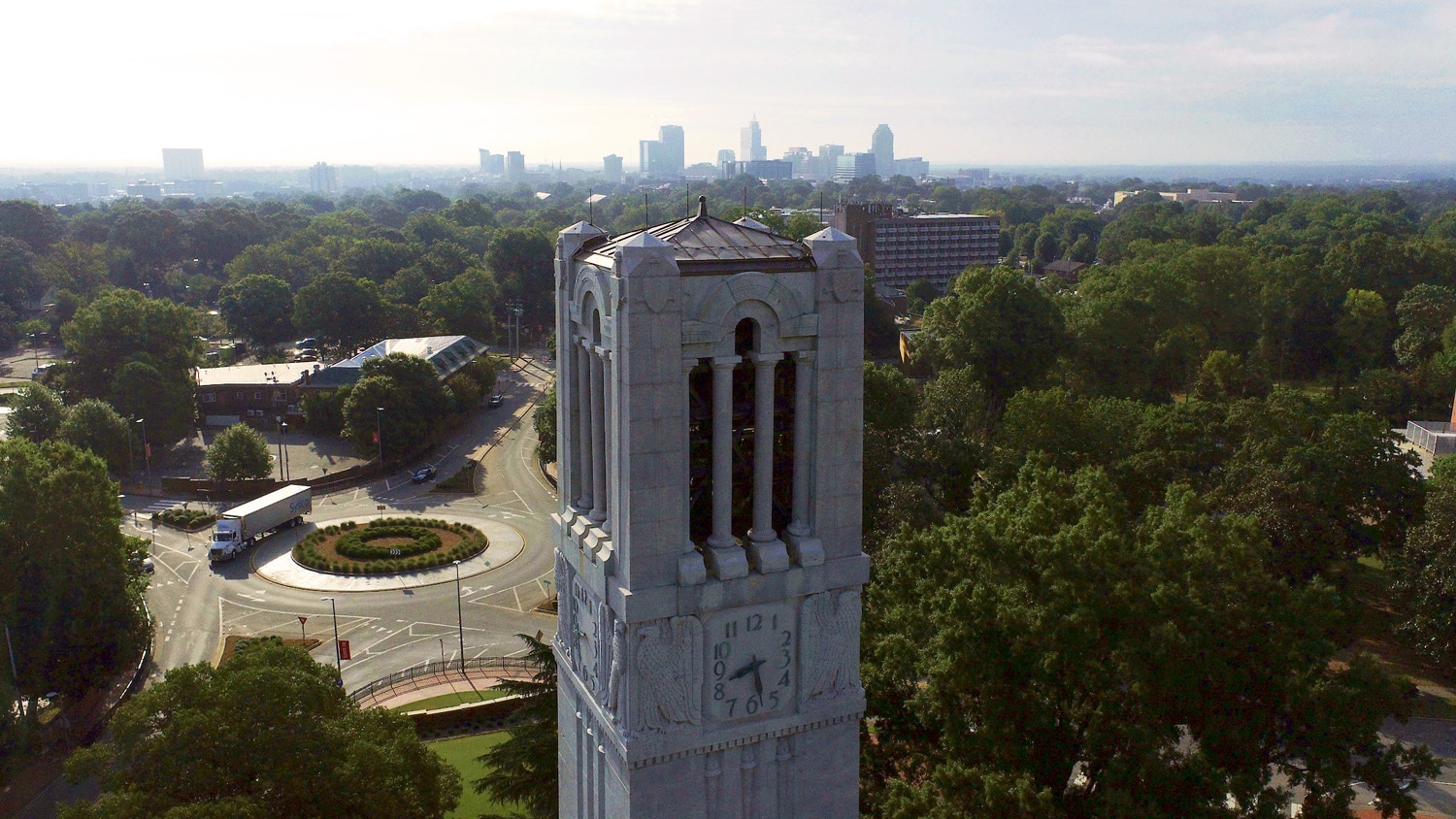 The Belltower stands tall and proud above Raleigh, with the downtown skyline close behind.