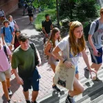 Students ascend a staircase during a busy class change.