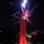 Colorful fireworks light up the sky above the Memorial Belltower.