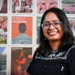 Portrait of Shilpa Giri in front of a wall of Technician newspaper covers.