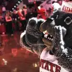 Mr. Wuf hypes up the crowd during a campus event.
