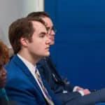 Andrew Bates '09 sits at a press briefing in the White House.