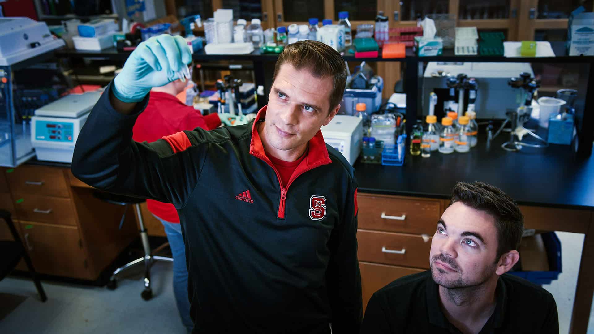 Rodolphe Barrangou, the Todd R. Klaenhammer Distinguished Scholar in Probiotics Research and the lead coordinator for the new biomanufacturing-focused faculty cluster, gazes at a sample alongside another researcher in his lab.