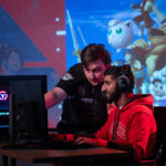 Two students collaborate around video games in Hunt Library's Teaching and Visualization Lab.