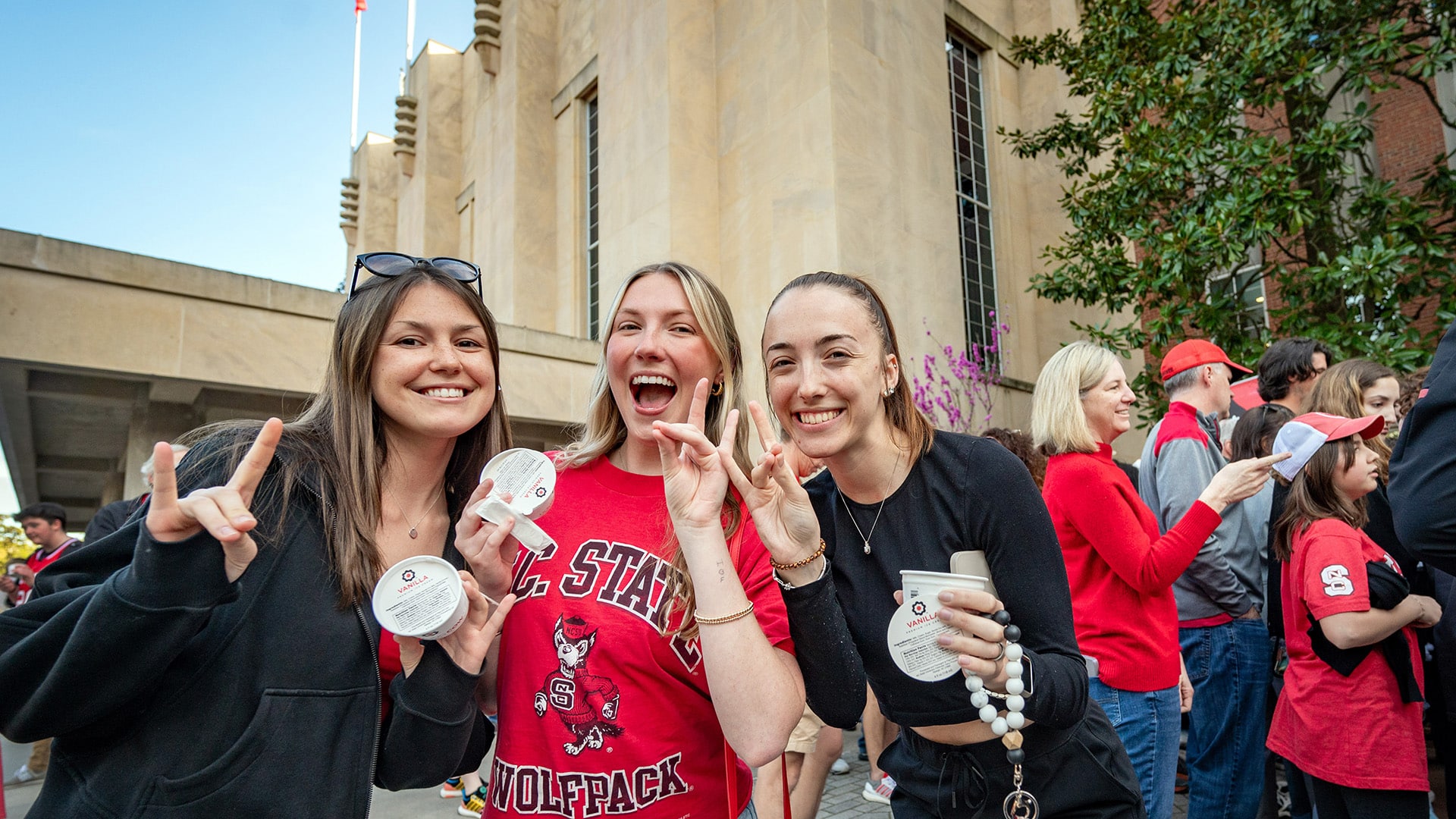 Students hold up their wolfies — and Howling Cow ice cream — to celebrate our Wolfpack men's and women's basketball teams advancing to the Sweet 16.