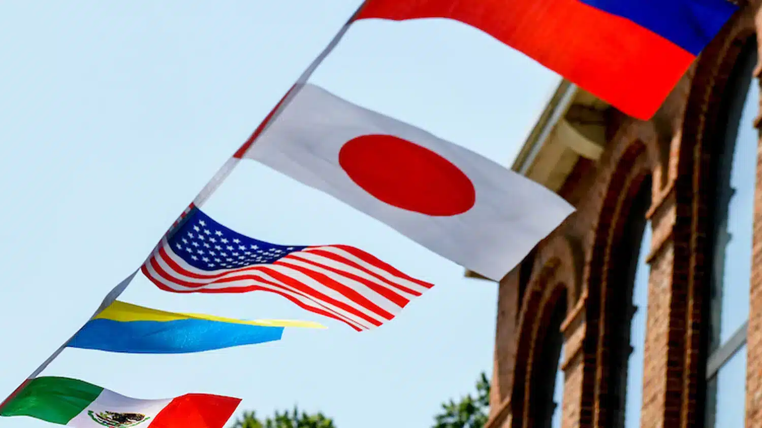 A string of national flags at NC State, including the flags of Japan and the United States.