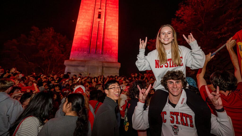 With the Wolfpack men's and women's basketball teams scoring major 2024 NCAA Championships wins, crowds of fans gather to celebrate at the Memorial Belltower.