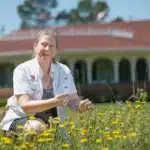 Danesha Seth Carley works in a pollinator garden at the Pinehurst golf course.