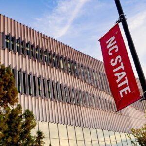 An "NC State" banner outside of Hunt Library.