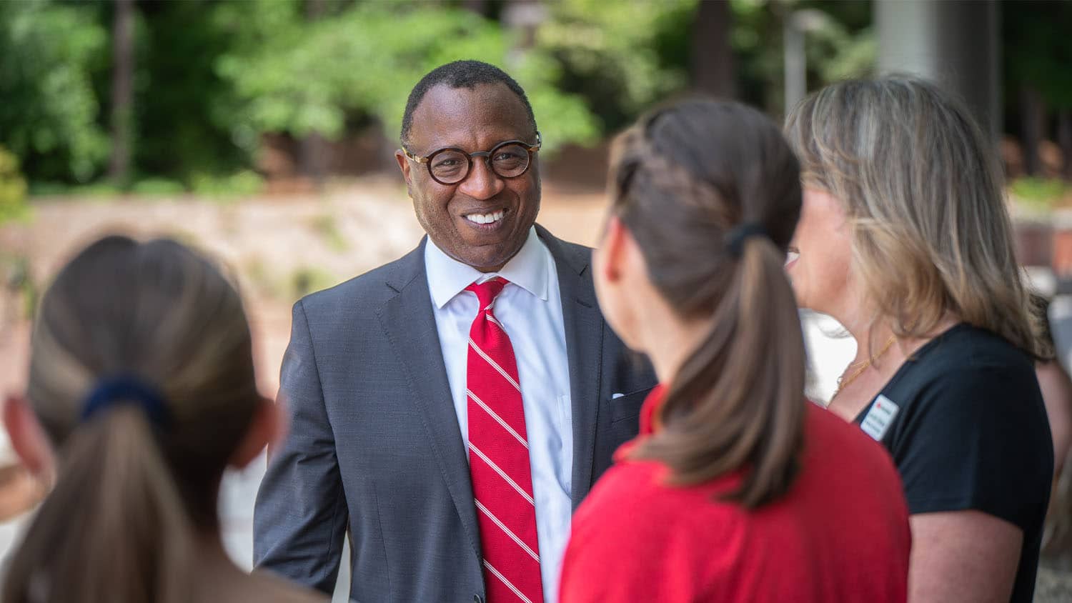 Chancellor Kevin Howell speaks with people at an employee appreciation event on Stafford Commons.