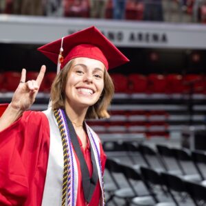 A Wilson College of Textiles graduate in red robes.