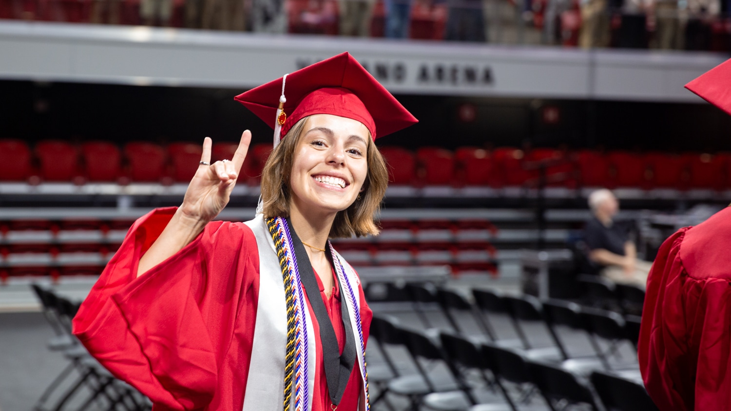 A Wilson College of Textiles graduate in red robes.