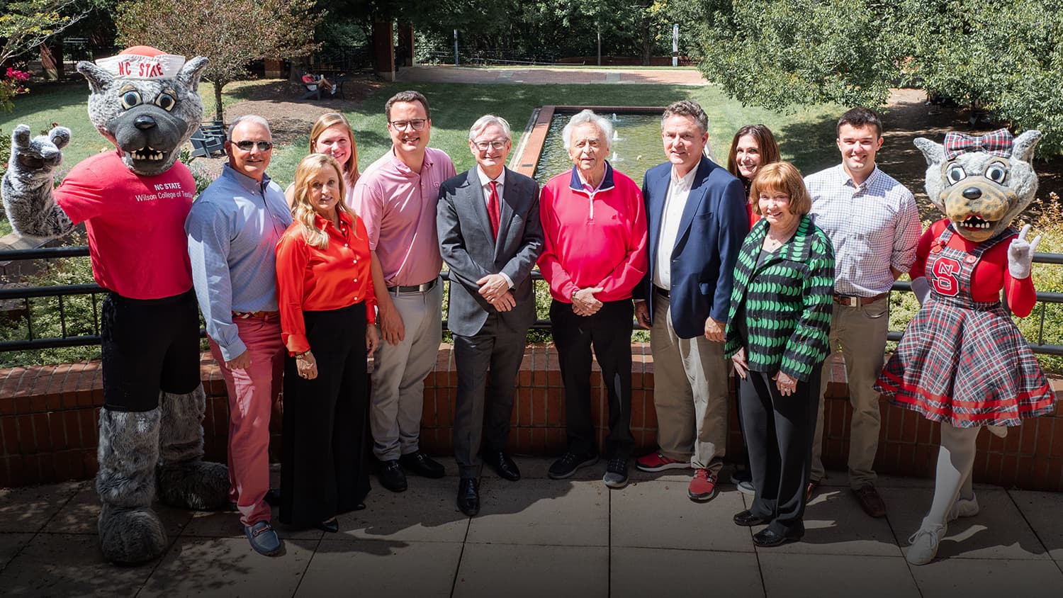 Three generations of the Wilson family celebrating the anniversary of their naming gift with Dean Hinks and the Wufs.