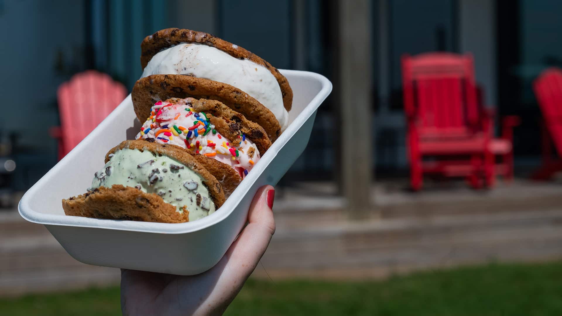 A row of three ice cream sandwiches outside of the Howling Cow creamery and dairy education center.