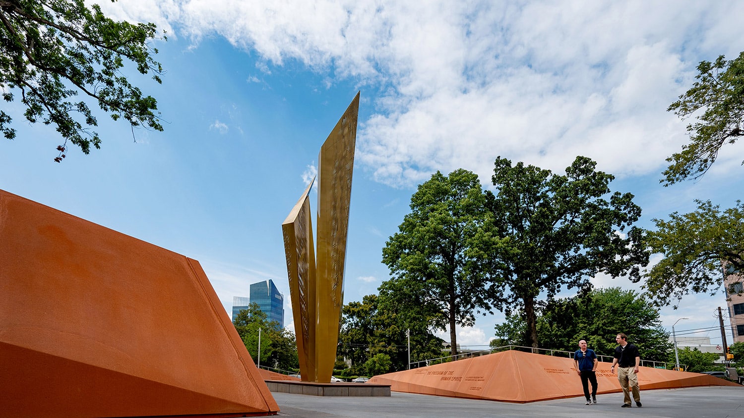 Two men walk past a sculpture in Freedom Park in downtown Raleigh.