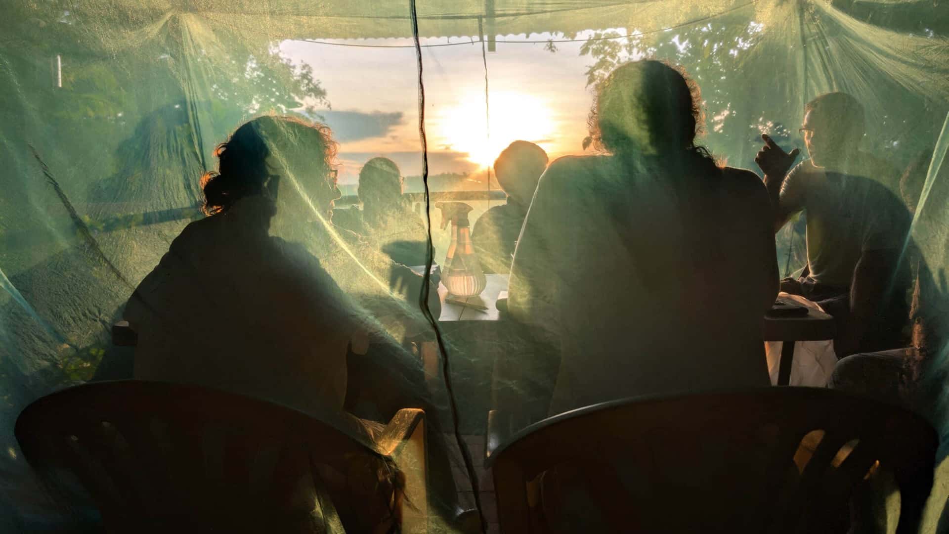 NC State researchers in a tent overlooking the Peruvian Amazon at sunset.