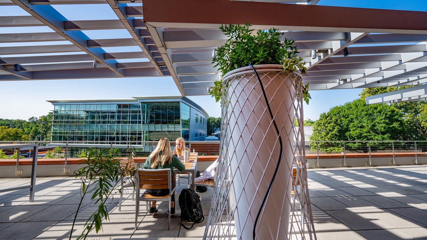 Two students sit at a table together on the third-floor terrace of Talley Student Union.