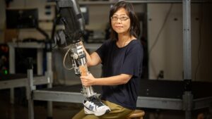 Helen Huang, Jackson Family Distinguished Professor of Biomedical Engineering in the Lampe Joint Department, holding a robotic prosthetic leg.